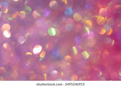 Blurry artsy shot of pink glitter tinsel with multicolor bokeh