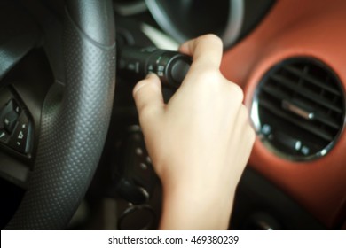 Blurry of asian Woman 's hands  Push button Turn Signal, button the car,selective focus on hand