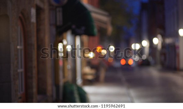 Blurry backdrop of sidewalk and street in\
Bruges in the evening for\
compositing