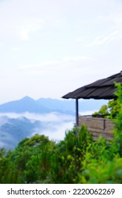 Blurry Background Of Bungalow In The Middle Of The Mountain Forest View To Floating Clouds