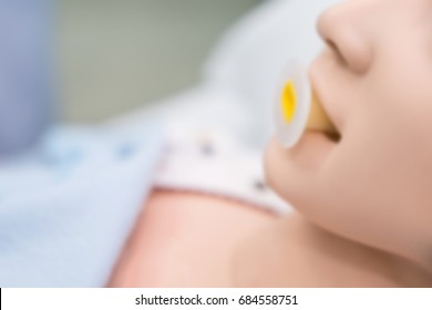 Blurry Background Of Dummy Patient On Oropharyngeal Airway To Open Her Airway.