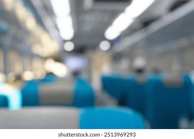Blurry background of interior inside train. People are sitting for travelling