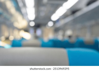 Blurry background of interior inside train. People are sitting for travelling
