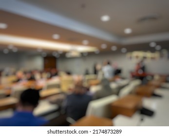Blurry background of meeting held in a hall - Shutterstock ID 2174873289