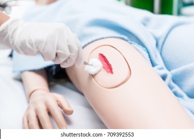 Blurry Background Of Nursing Student Were Trained How To Wound Care Patient. She Practice Training With The Doll Of Patient, Before Treatment To The Real Patient.