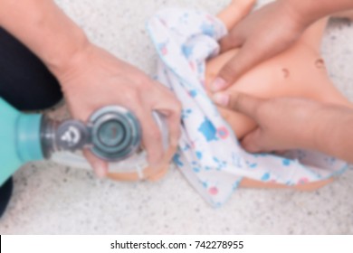 Blurry Background of Nursing students are learning how to rescue the baby patient in emergency. CPR training with Baby doll. Closed-up. Soft focus.