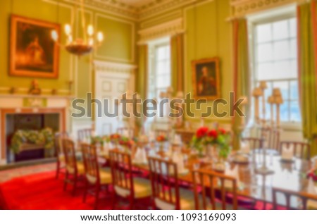 Blurry background texture. Defocused view of luxurious dinning room with traditional Euopean style interior. Concept of luxury, noble, upper class and warm atmosphere. 