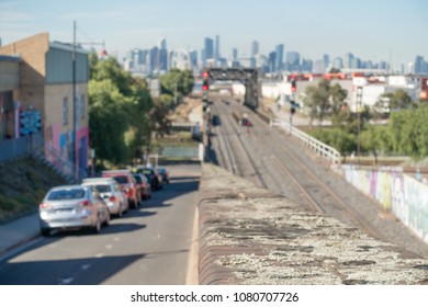 Blurry Background Texture Of Suburban Street Near Rail Bridge Over Maribyrnong River With Melbourne City In Distance