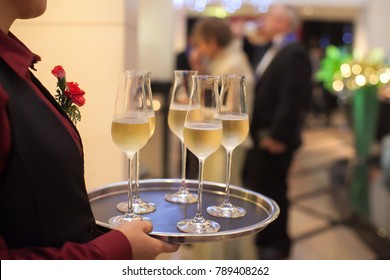 Blurry background waiter serving champagne to customer in restaurant. - Powered by Shutterstock