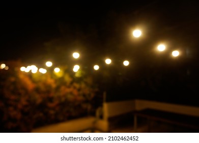 Blurry Backyard With Light Bulb At Night 