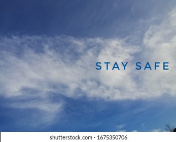 blurry bqckground of white clouds with text stay safe