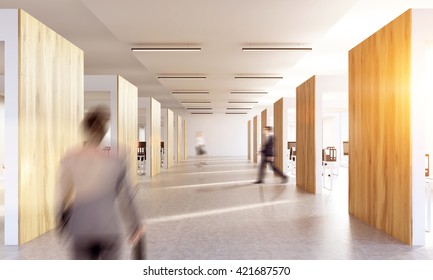 Blurry Businesspeople Walking In Office Interior With Sunlight