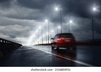 Blurry Of Car Driving Fast On Bridge During Hard Rain With Storm Clouds As Background,selective Focus On Ground And Long Shutter Speed Exposure.Concept Of Rainy Season,transportation And Travel.