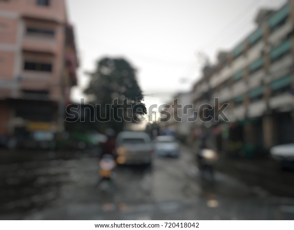 Blurry\
city, has flood on street, traffic in the\
city.