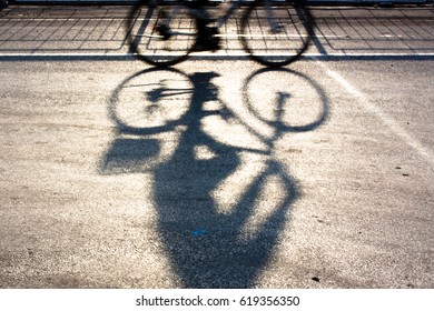 Blurry cyclist silhouette and shadow on a protected bike path - Powered by Shutterstock