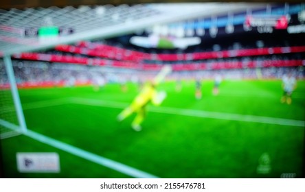 Blurry And Defocused, Football Match Competition With Blur Effect. Goalkeeper Jump In Football Match. Blur Background Concept.