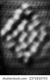 A blurry dreamy view of a repeating pattern in a black and white monochrome.