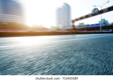 Blurry Empty Asphalt Road With Road Sign And Modern Building In Midtown Of Hangzhou In Blue Cloud Sky