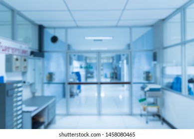 Blurry Empty Interior Operating Room Door  And Equipment In Hospital.Medical Device For Surgeon Surgical Emergency Patient In Blue Tone Style.Save Life Medical Treatment Concept.