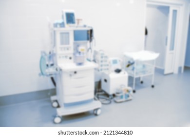 Blurry Empty Interior Operating Room And Modern Equipment In Hospital.Medical Device For Surgeon Surgical Emergency Patient In Blue Tone Style.Save Life Medical Treatment Concept.