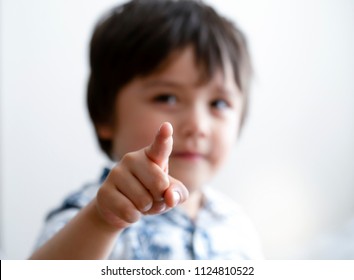 Blurry Face Of Little Boy Finger Pointing At Camera, Selective Focus Of Kid Primary School Boy Pointing At You With His Finger, Spoiled Children Concept