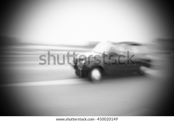 The\
blurry focus scene of black taxi car on city road represent the\
vehicle and transportation concept related\
idea.