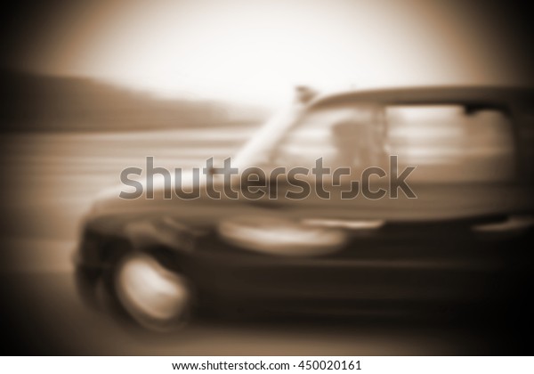 The\
blurry focus scene of black taxi car on city road represent the\
vehicle and transportation concept related\
idea.