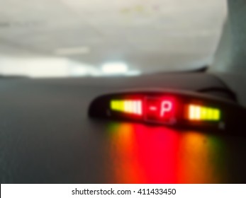The blurry focus scene of parking sensor monitor on the car control dashboard represent the car part equipment concept related idea.