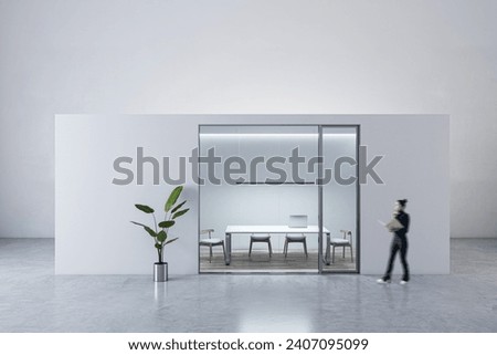Blurry happy young woman walking in modern light concrete and glass office box interior with mock up place on walls and wooden floors. Designer concept