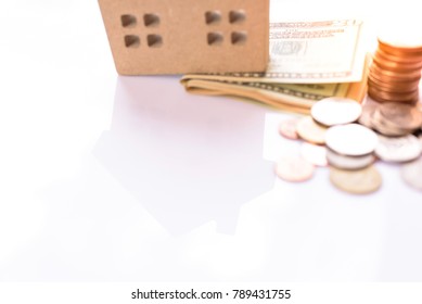 Blurry House Model And Money On White Background.Home Loan For New Family.Loan For Real Estate Concept.
