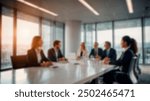 Blurry image of a business meeting in a modern office setting with large windows and natural light. Suitable for corporate and business themes