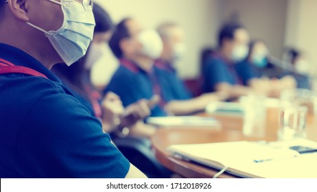 Blurry Image Of Business People Wear Masks To Prevent Coronavirus (Covid-19) In Meeting Room. Startup Business Team Brainstorming On Meeting Workshop. 