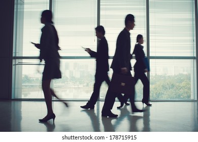 Blurry Image Of A Business Team During A Rush Hour 