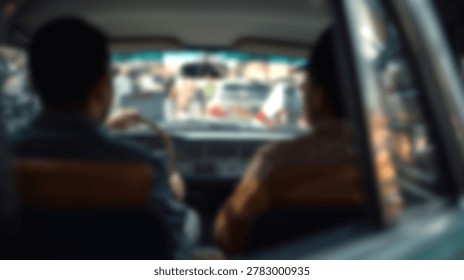 A blurry image captures the interior of a car with two people, observing the traffic ahead. The focus is soft, creating a sense of motion and urban life.