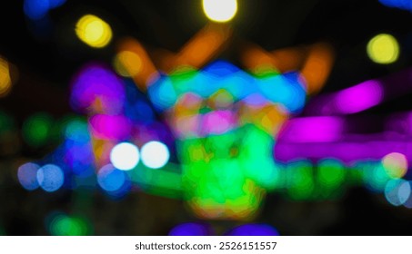 Blurry image of carousel ride at an amusement park at night festival with bokeh background. Abstract blurry photo of amusement rides in night festival city park with colorful lights at night. - Powered by Shutterstock