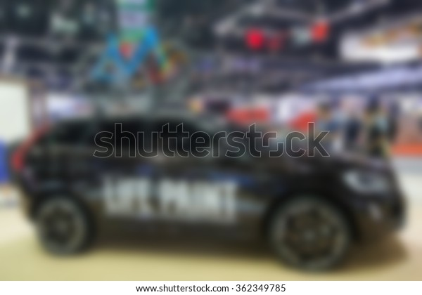 blurry image of  cars in\
motor show