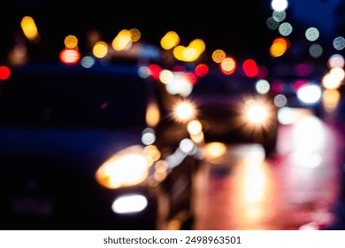 A blurry image of cars on a wet road at night. The lights of the cars are reflected in the wet pavement, creating a sense of movement and energy. The scene is both chaotic and beautiful - Powered by Shutterstock