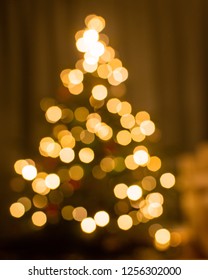 Blurry Image Of A Chrismtas Tree With Lights In It.