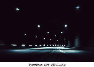 Blurry image of a dark tunnel with dim lights.