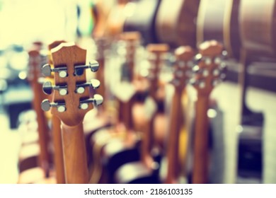 Blurry Image Of Guitar Tuning Knob With Many Guitar Background In Musical Showroom At Musical Store. Instrument Concept.