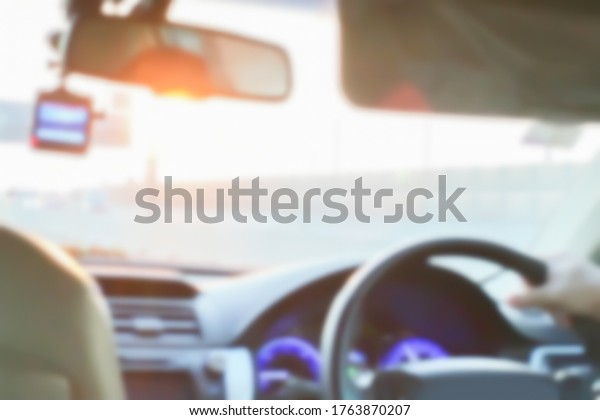 Blurry image interior vision\
perspective of the car drive by brand new driver at expressway on\
twilight summer season for safety insurance business\
background.\

