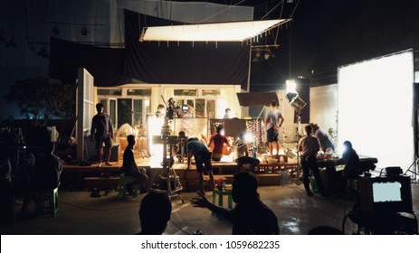 Blurry image of making movie video in big production studio and film crew team shooting or recording by professional digital camera and lighting set equipment. - Shutterstock ID 1059682235