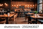 Blurry image of a modern, cozy café interior with warm lighting, wooden furniture, and an inviting atmosphere. Perfect for backgrounds