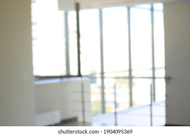 Blurry Image Of An Office Lobby With Glass Walls.