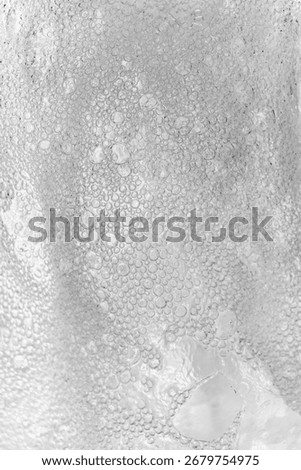A blurry image of a person's face with a lot of bubbles. The bubbles are scattered all over the image, creating a sense of chaos and disarray. Scene is one of confusion and disorientation