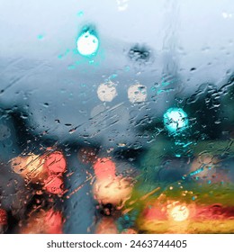 A blurry image of a rainy day with lights in the background. The raindrops on the window create a sense of movement and energy, while the lights in the background add a sense of depth and contrast - Powered by Shutterstock