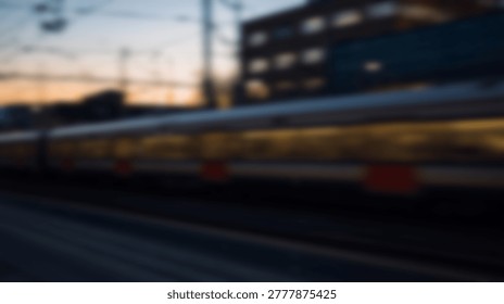 A blurry image of a train speeding through a city at dusk, with the sky and buildings in the background.