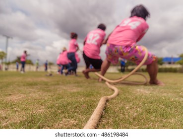 Blurry image of the tug of war team competition during the company sport day