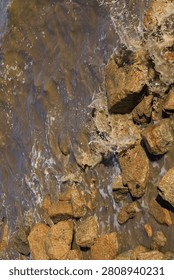 Blurry image, waves, massive and terrifying water crashing against rocky shore after a dam broke in China: Use for website banner backgrounds, backdrops, and mobile screens.