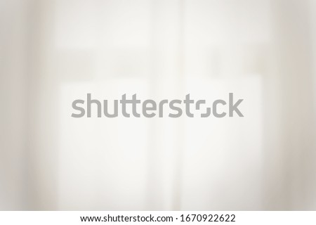 Blurry image of white curtain with morning sunlight shining through.can. E used as background or backdrop with space for runaround or wraparound text 
